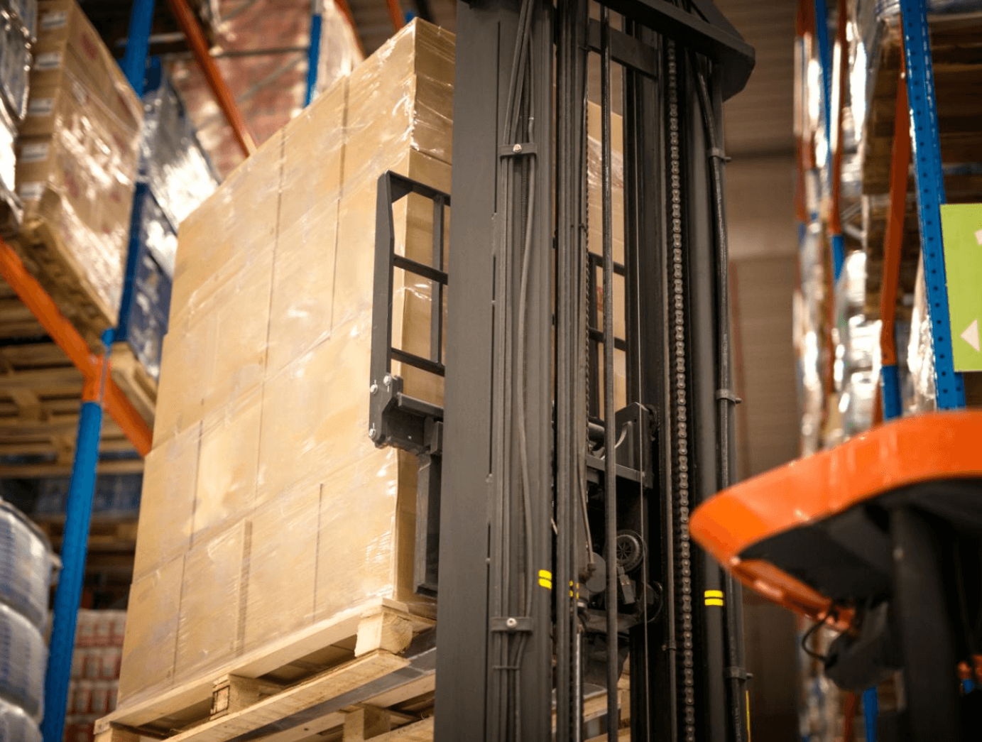 warehouse forklift transporting ignition coil supply pallets