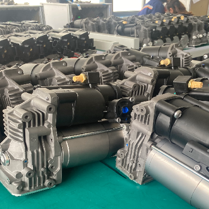 Rows of heavy-duty AC compressors on assembly line