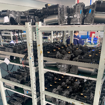 Heavy-duty AC compressors stacked on factory shelves