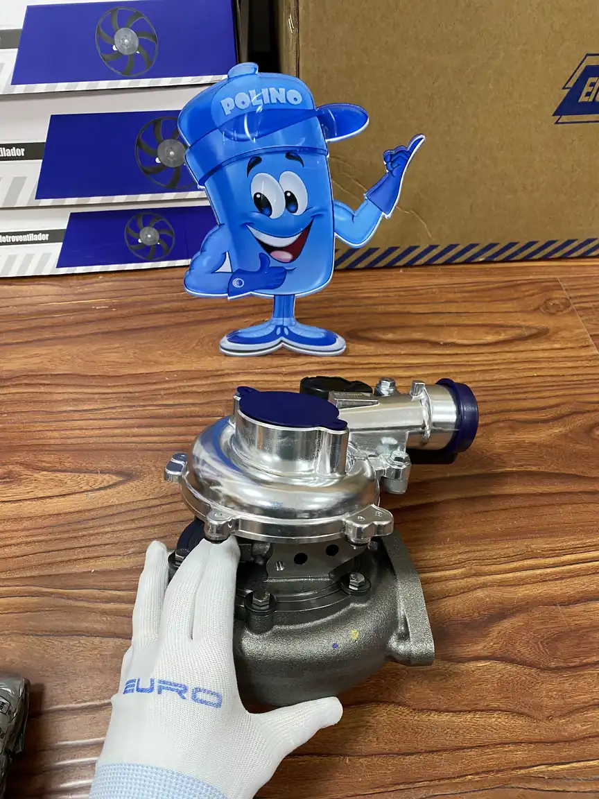 Gloved handling of an assembled turbocharger with visible housing interfaces and protective port caps.