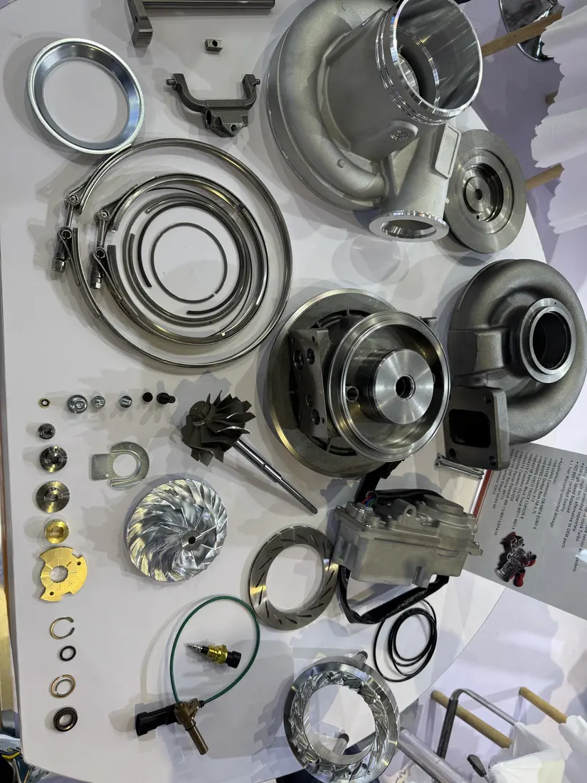 Real display of turbocharger housings, rotating parts, retaining hardware and an actuator