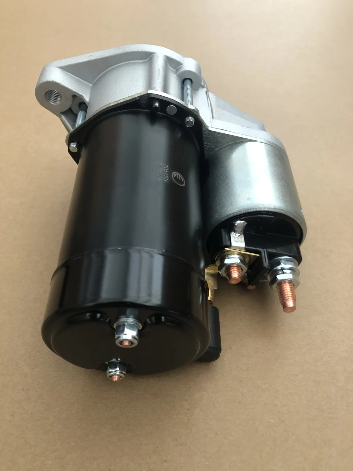 Rear-side view of a starter motor showing the solenoid housing and external electrical terminals