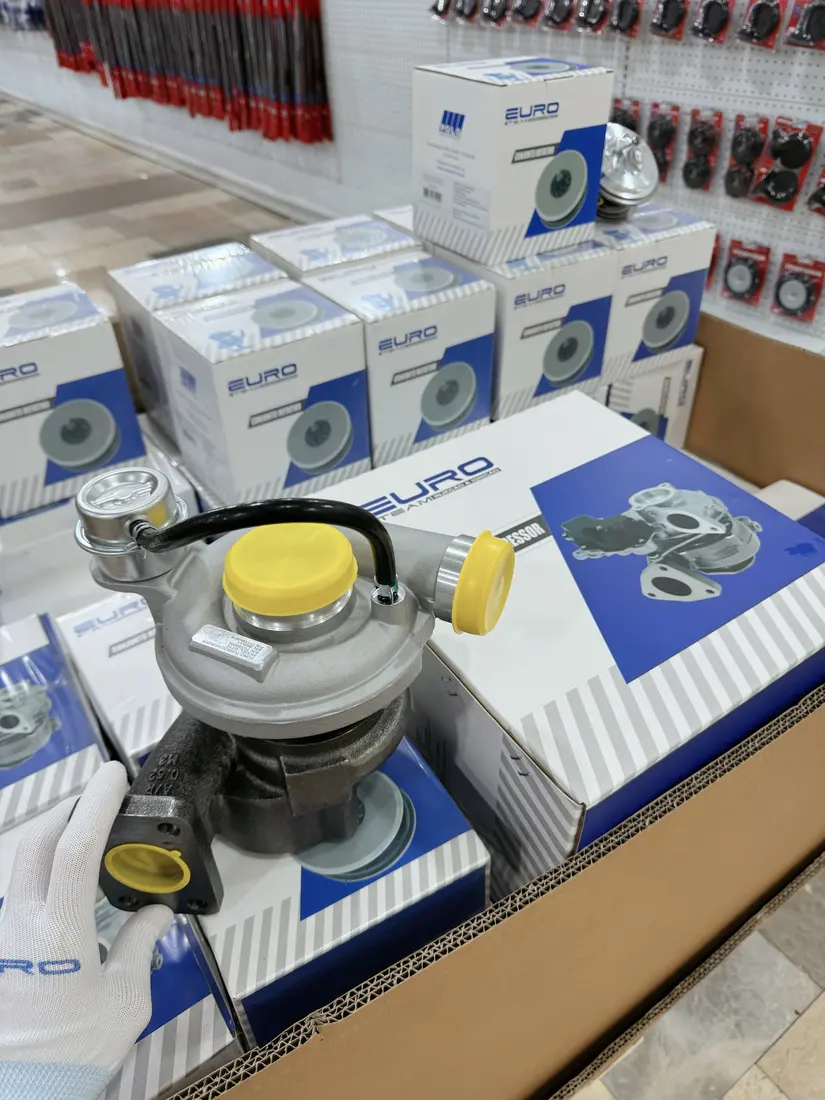 Real turbocharger showing compressor outlet neck, pneumatic actuator and connecting hose