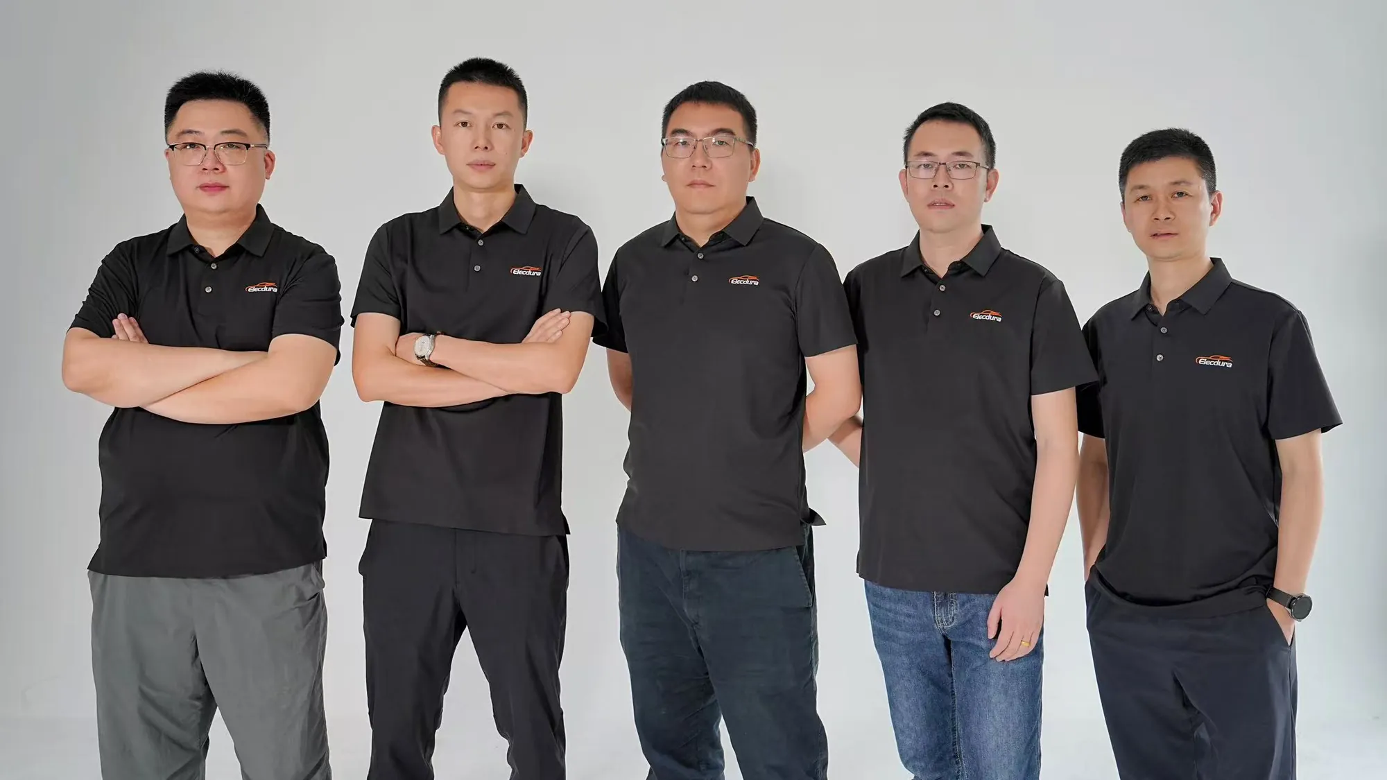 Five people wearing Elecdura-branded shirts in a studio group photograph.