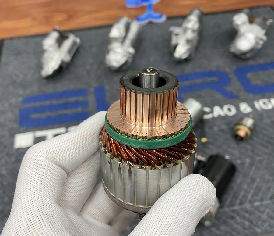 Handheld starter armature showing the copper commutator and windings.