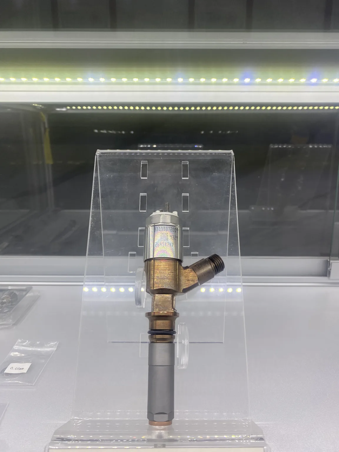 Diesel injector display sample with its exterior body, side connection and sealing ring visible.