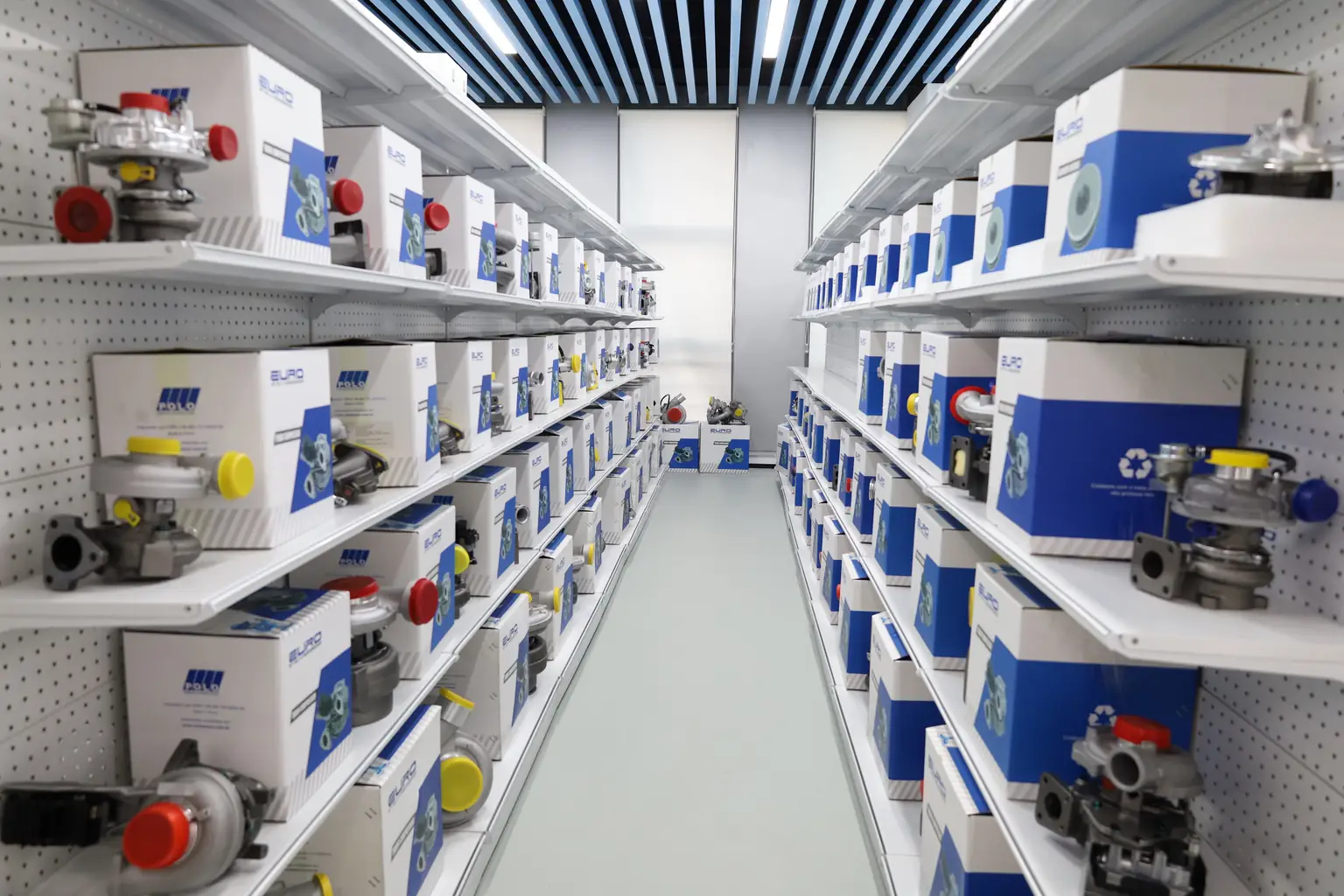Turbocharger assemblies displayed on shelves with protective port caps and branded cartons.