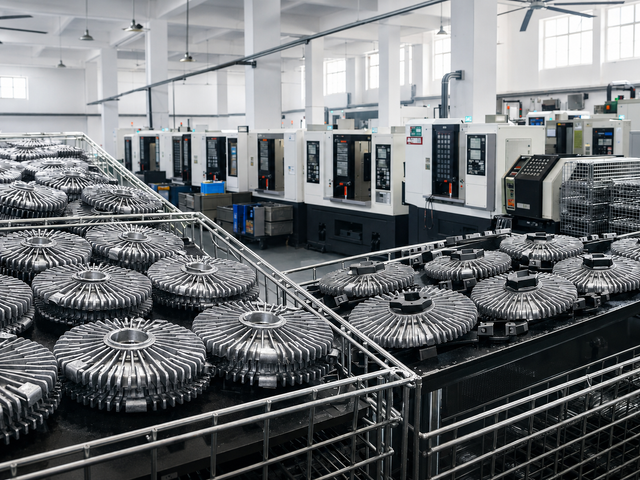 Fan clutch production workshop with machining equipment and organized parts storage