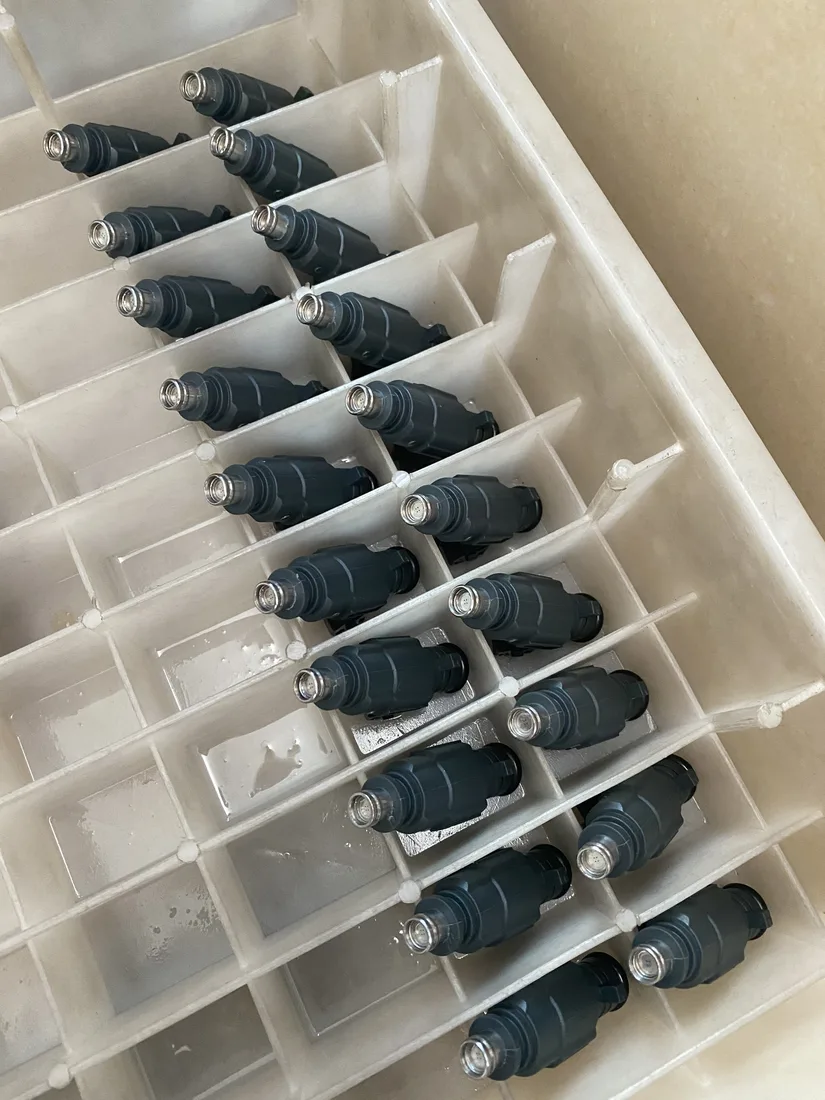 Diesel injectors separated by white tray dividers