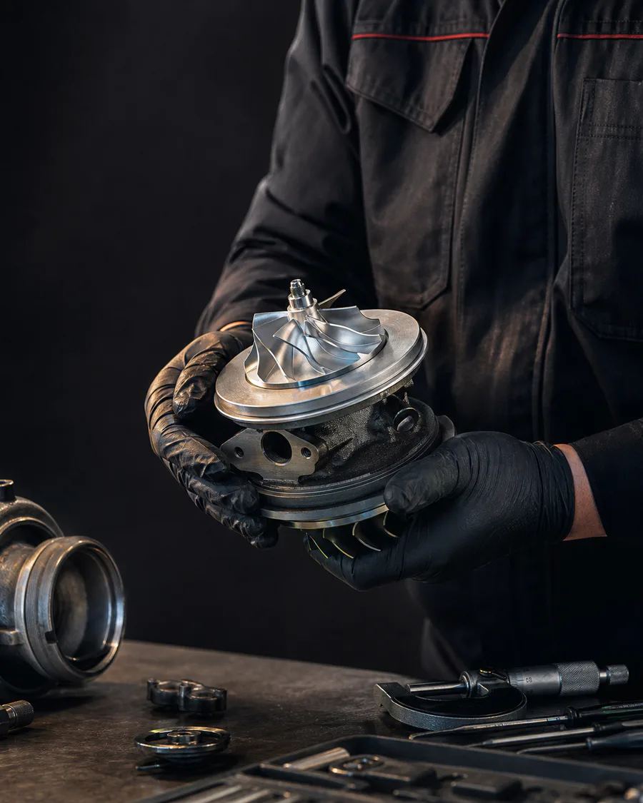 Turbo rebuilder inspecting a CHRA cartridge in a workshop