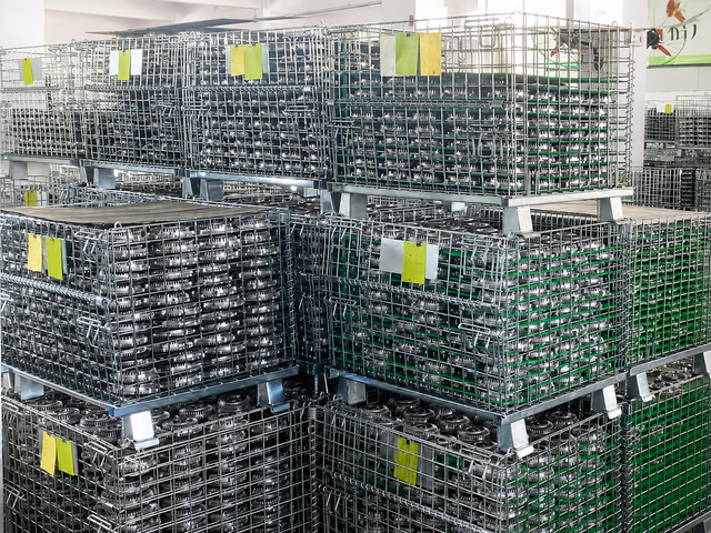 Bulk fan clutch components stored in metal baskets for heavy-duty parts production