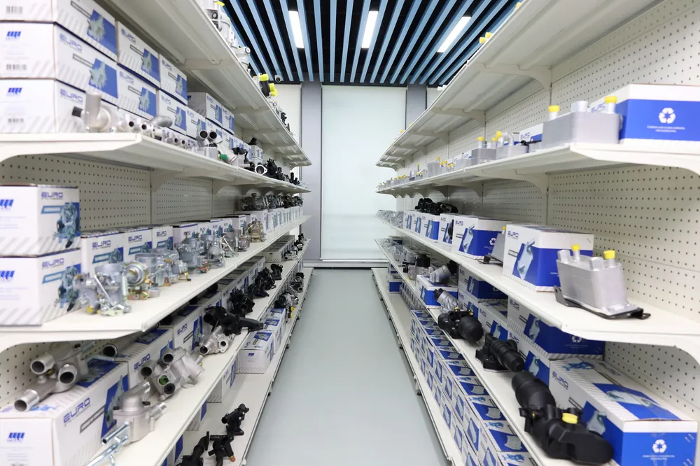 A real showroom aisle with automotive parts displayed on both sides.